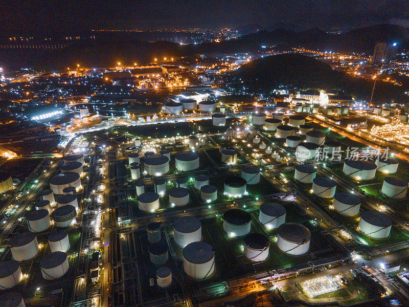 Aerial view Oil refinery oil business investment theme with a background of mountains and sky.The factory is located in the middle of nature and no emissions. The area around the air pure.